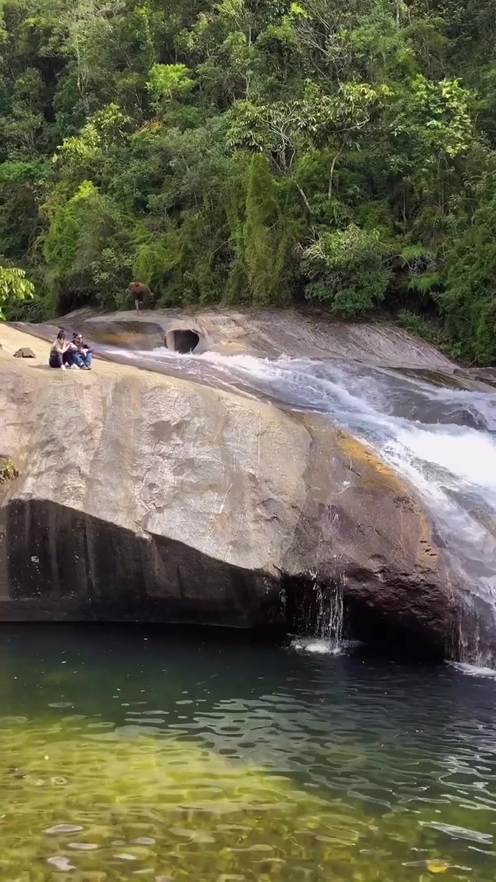 Natural Water Slide Adventure in Lush Greenery