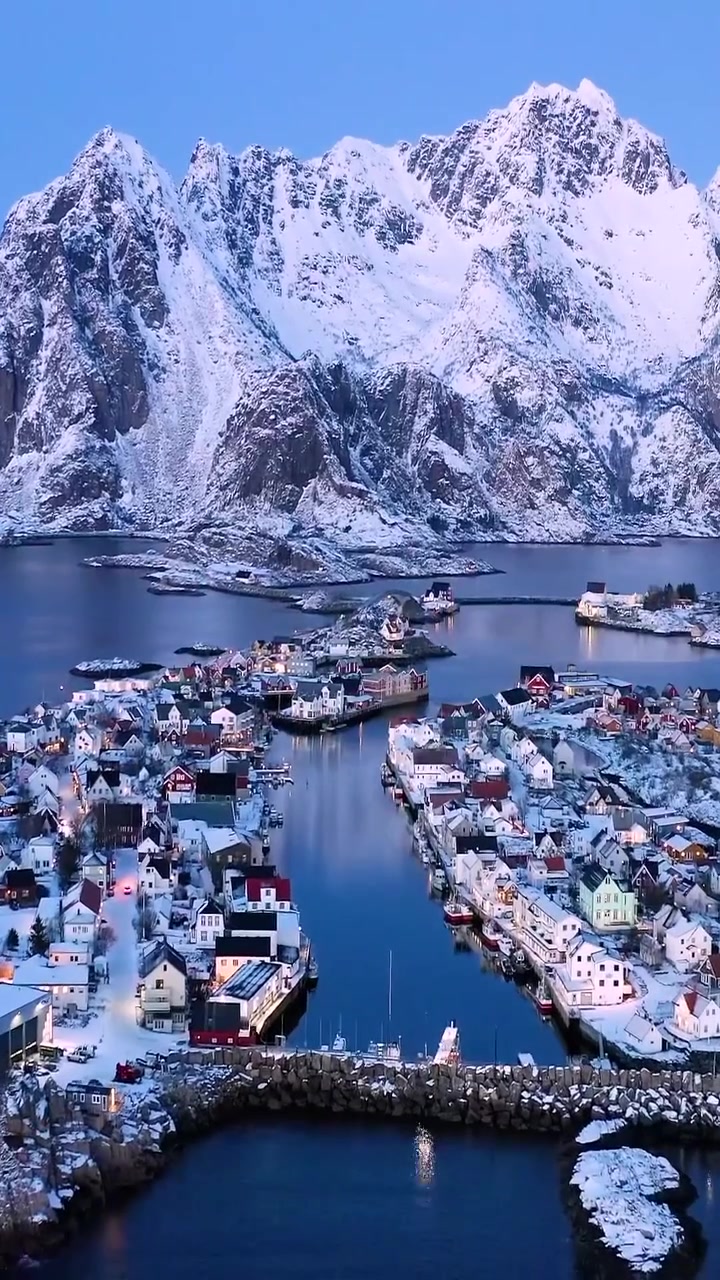 Aerial View of Snow-Covered Village and Mountains
