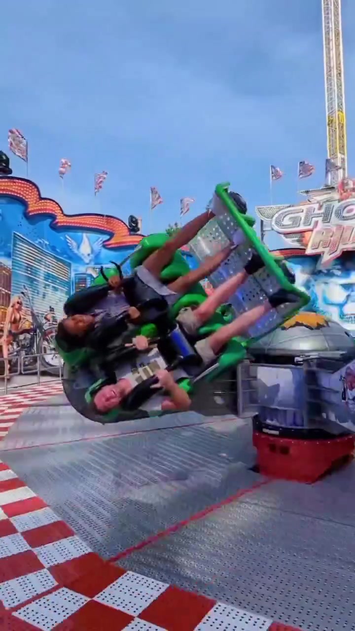 Motorcycle-Themed Amusement Park Ride in Action