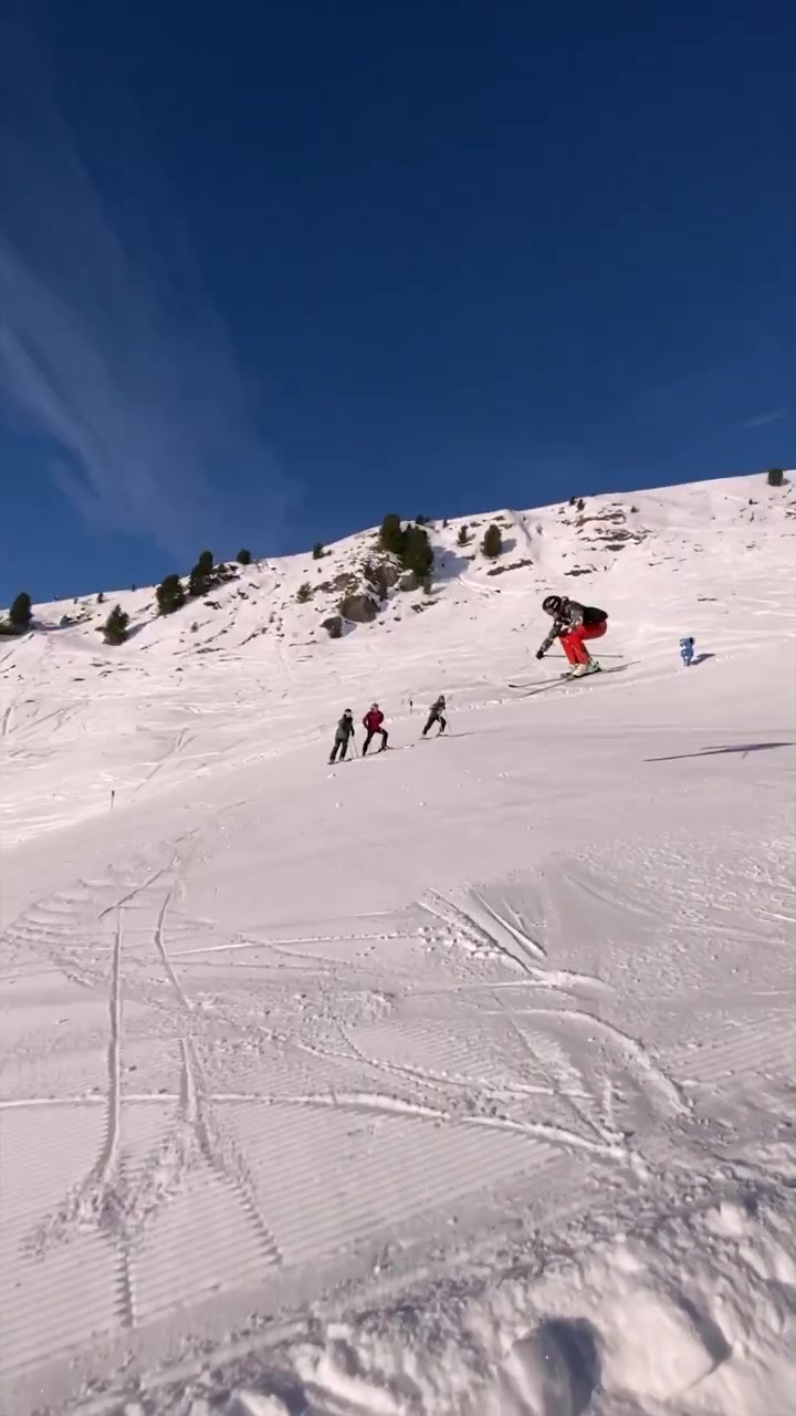 Skiing Down a Snowy Slope on a Sunny Day