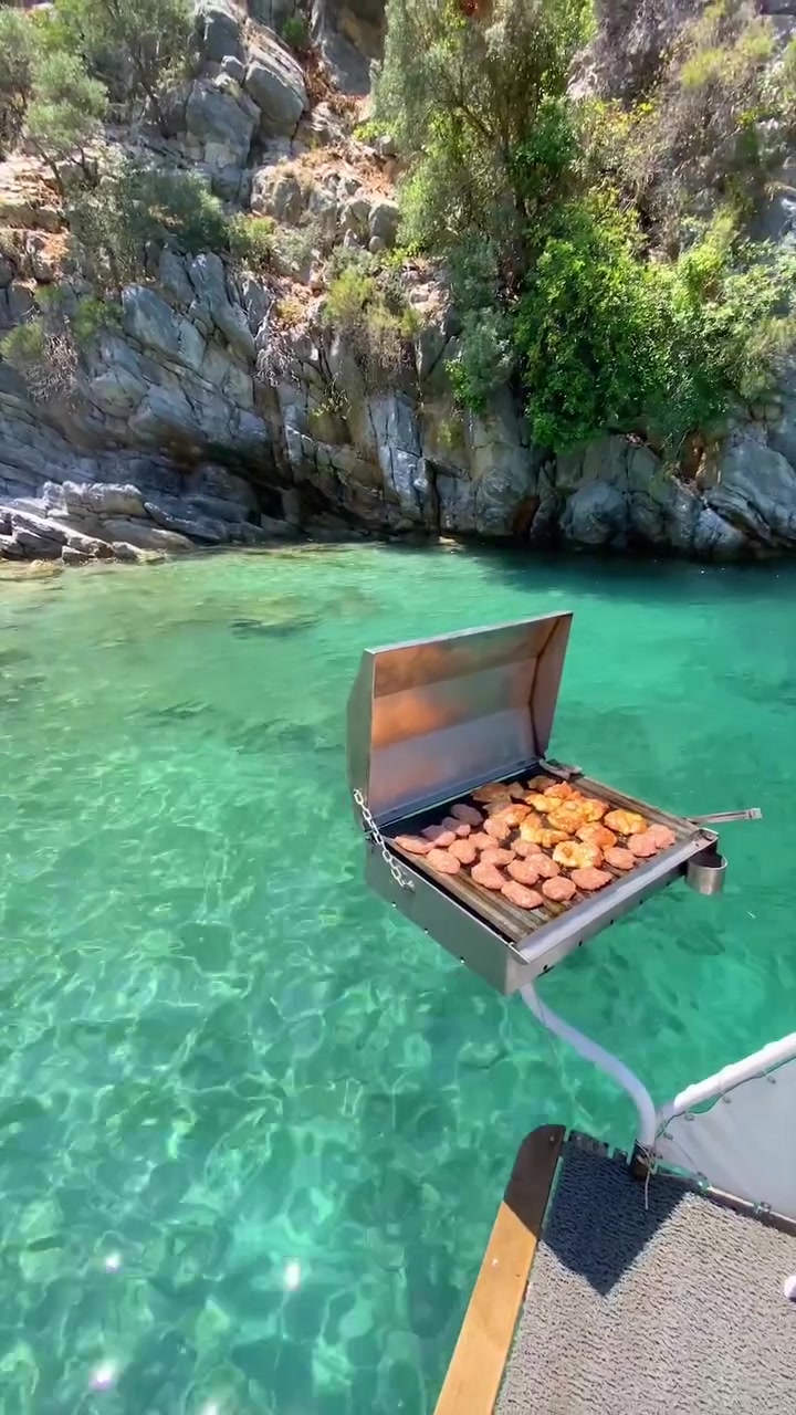 Floating Grill: Cooking on a Boat in Clear Water