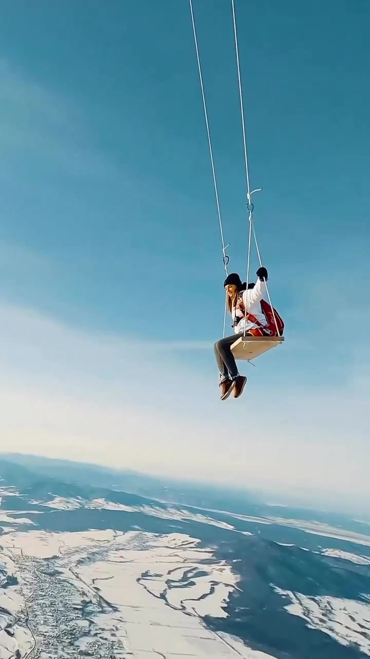 Extreme Aerial Swinging: Thrilling Snowy Mountain Views