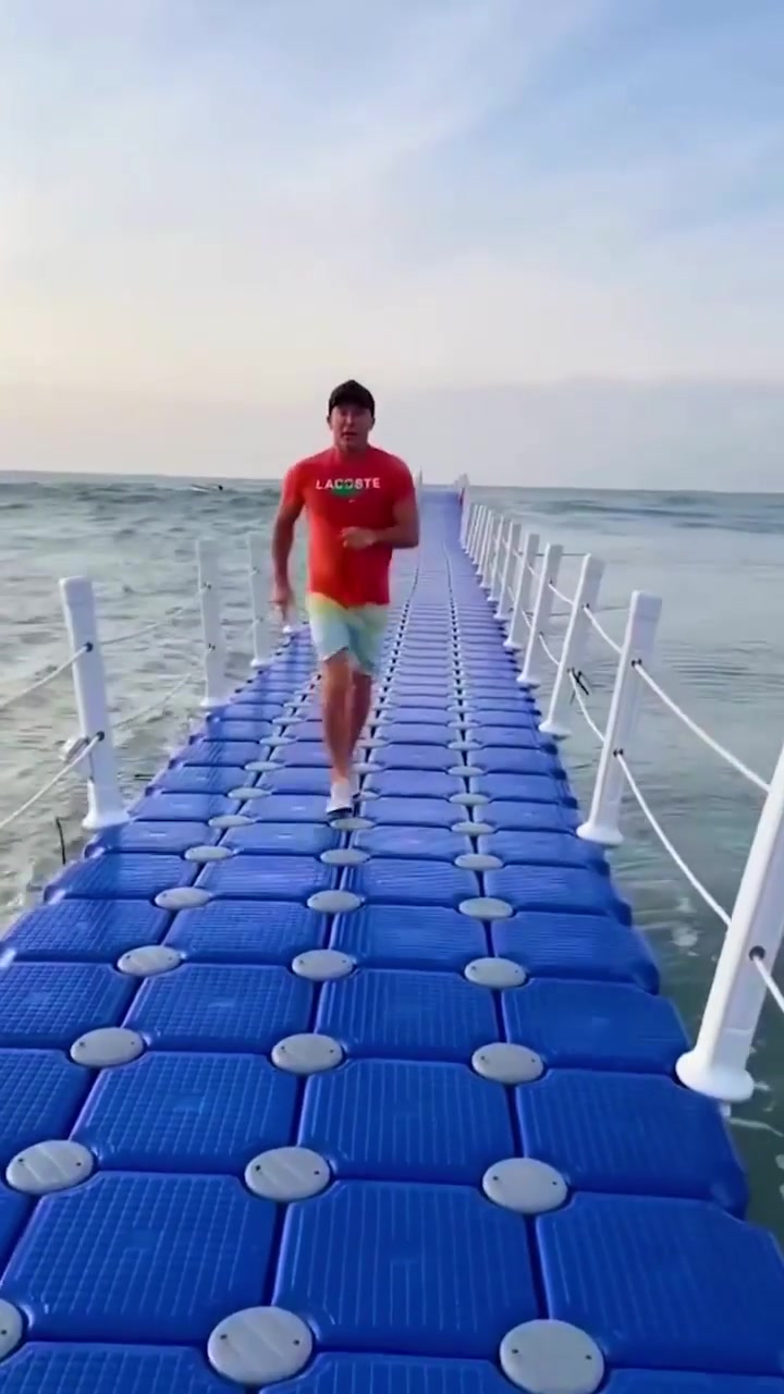 Man Running on Floating Dock in Lacoste Shirt