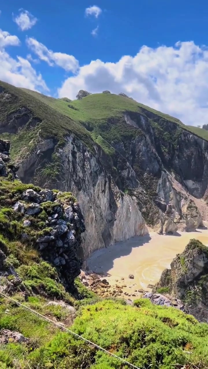 Coastal Scenery: Green Hills, Rocky Cliffs, Turquoise Water