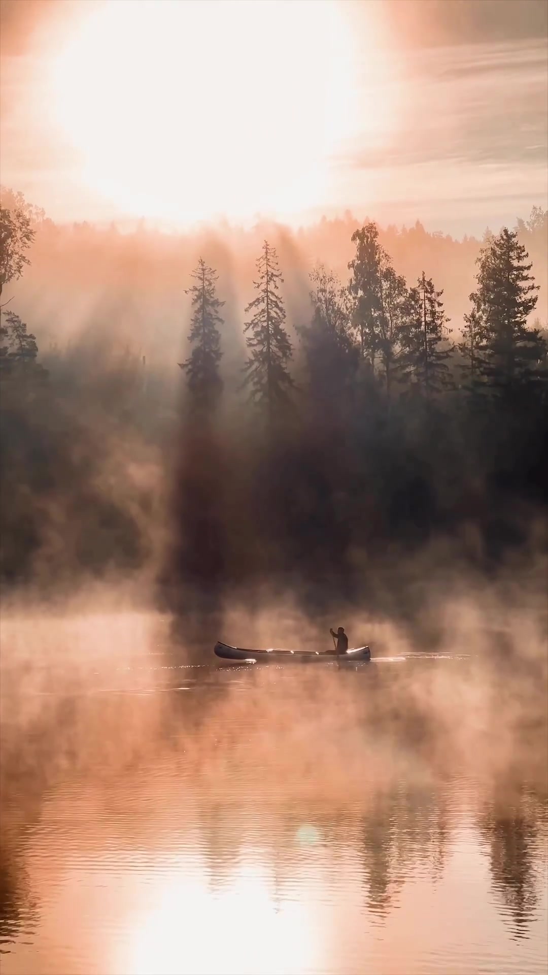 Canoeing on a Misty Lake at Sunrise