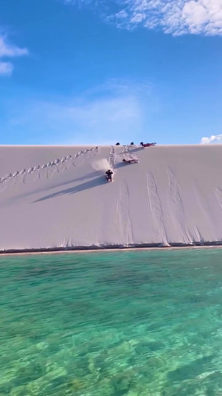 Sandboarding into Turquoise Water: Dune Thrills
