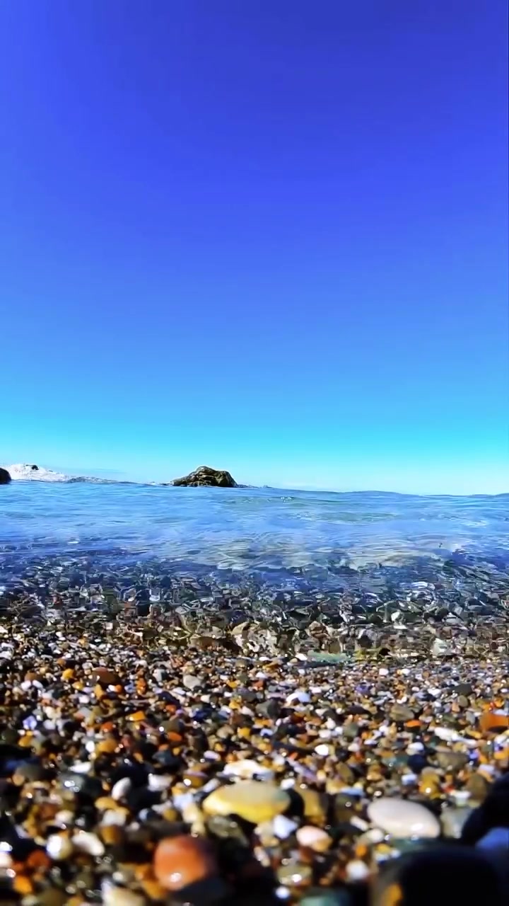 Ocean Waves Crashing on Pebble Beach