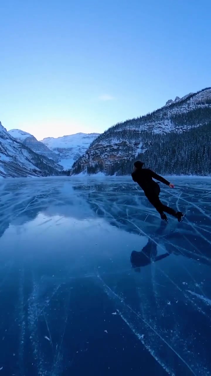 Ice Skating on a Frozen Lake with Mountain Views