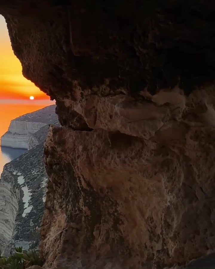 Breathtaking Sunset View from a Cave's Natural Opening