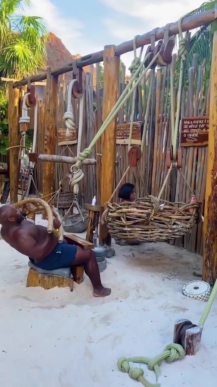Beach Workout: Man Uses Wooden Swing for Exercise
