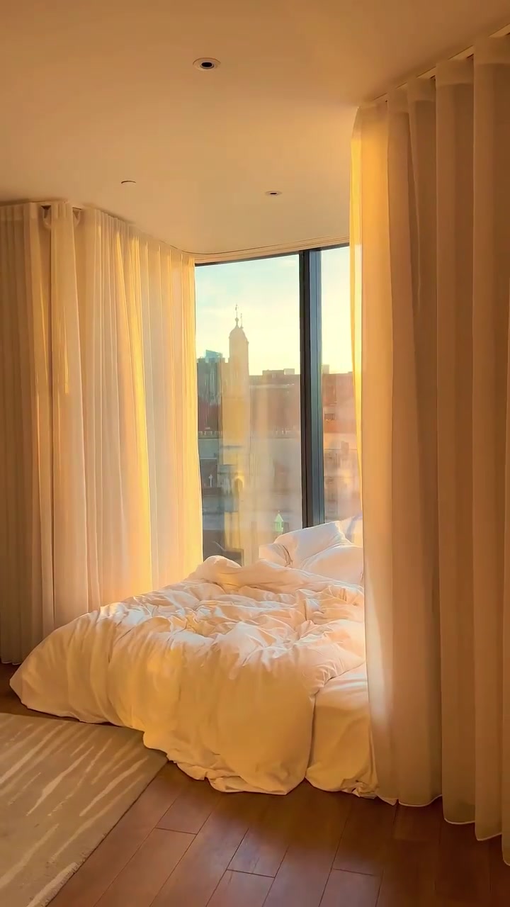 Cityscape Bedroom View: Cozy Morning Light
