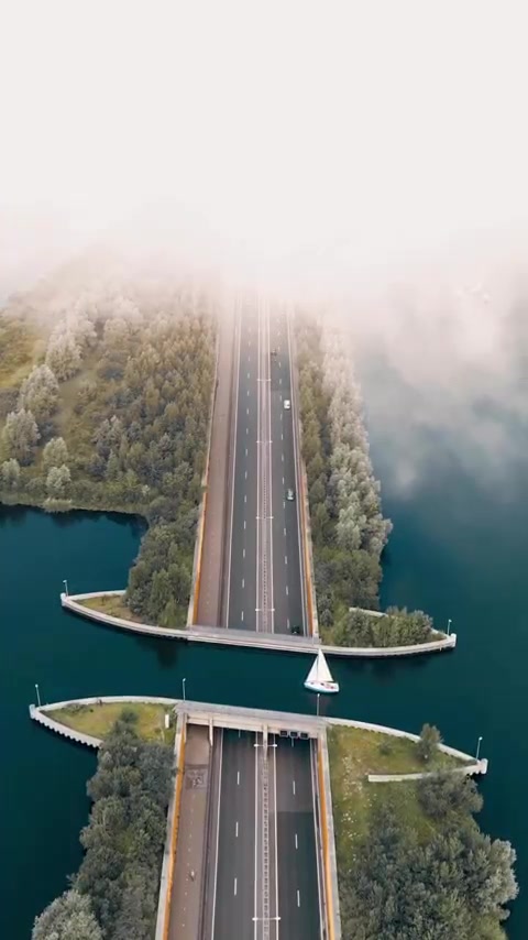 Aerial View of a Bridge with Sailboat