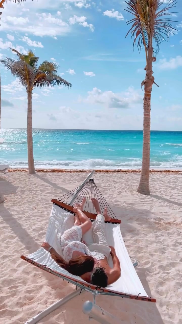 Couple Relaxing in Hammock on Tropical Beach