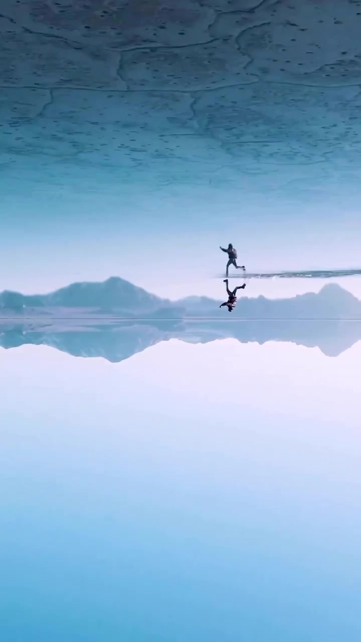 Person Walking on Water with Mirrored Reflection