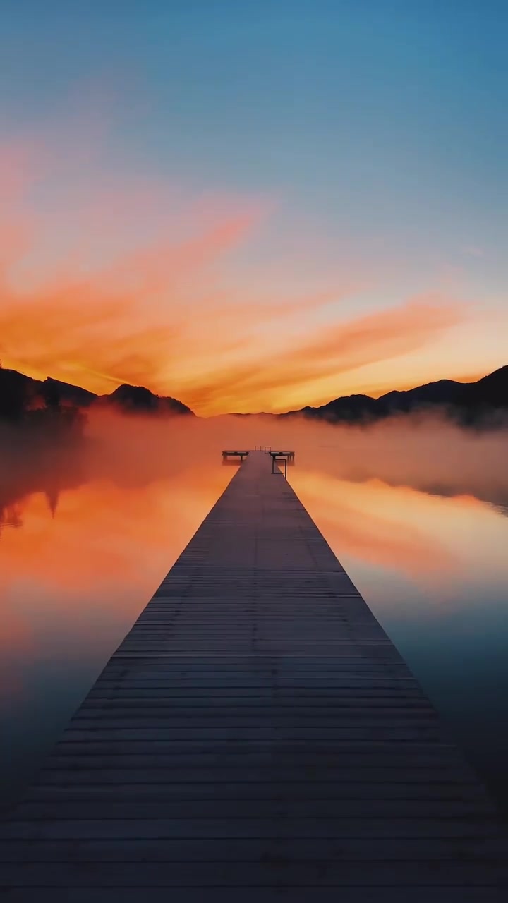 Sunset Lake Pier: Serene Reflection of Vibrant Sky