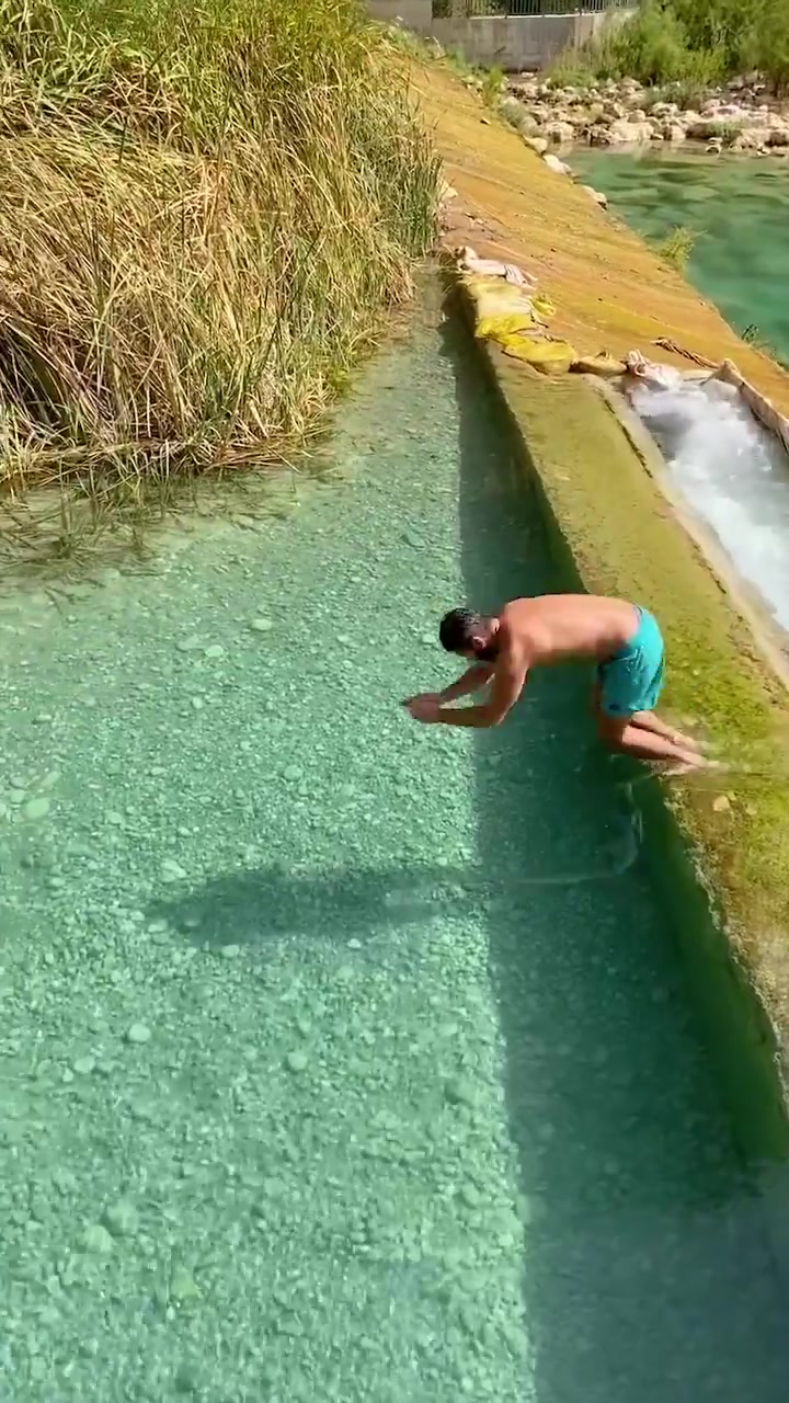 Man Jumping into Clear Water in Antalya